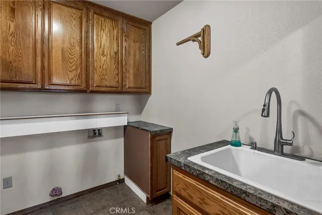 a bathroom with a sink a toilet a mirror and shower curtain