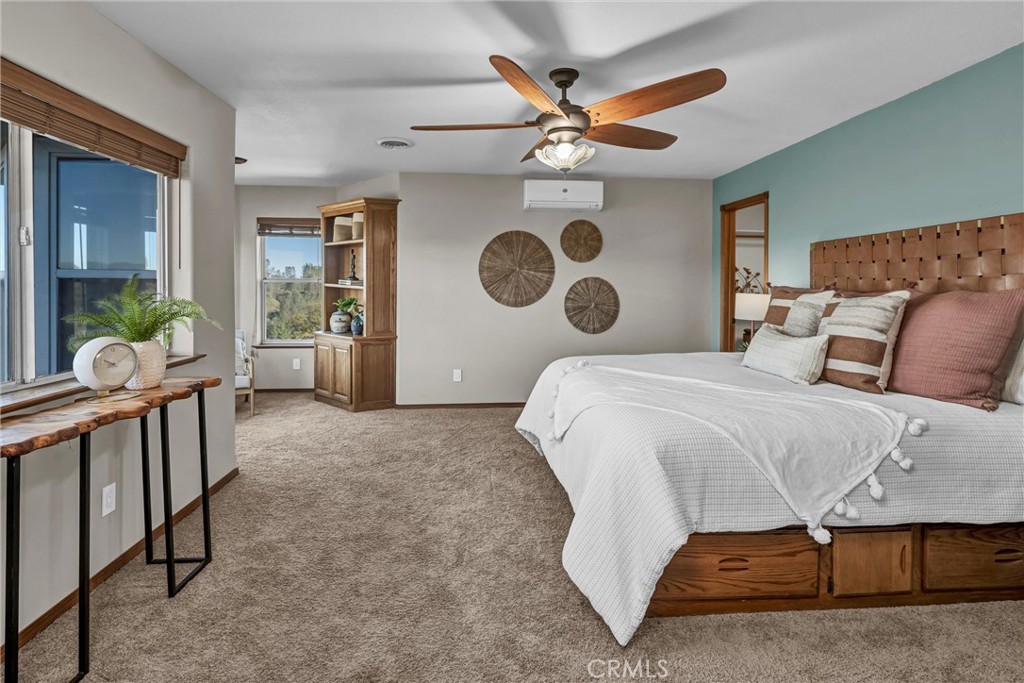 20250 Black Bass Pass Road Lower Lake, CA 95457 - Photo 27 of 66 a bedroom with a bed and a chandelier