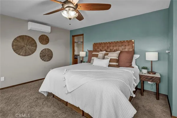 a living room with a bed furniture and a chandelier