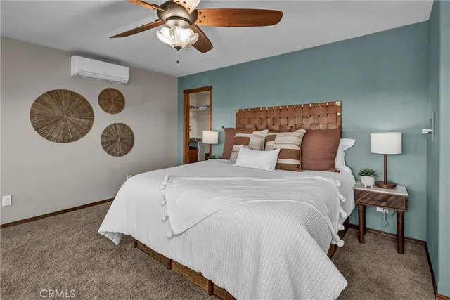a living room with a bed furniture and a chandelier