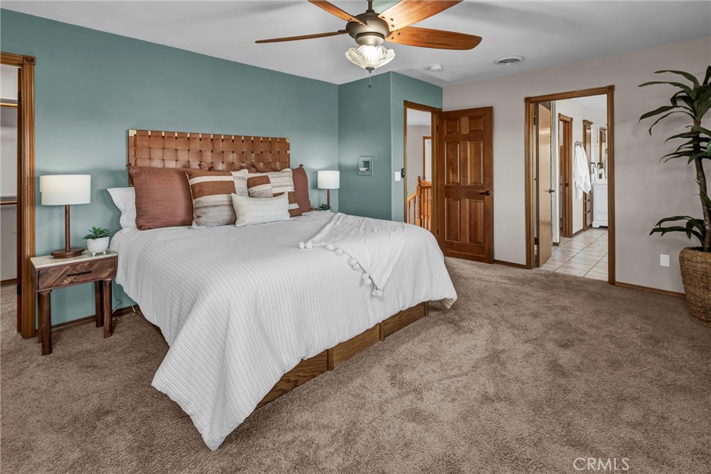 20250 Black Bass Pass Road Lower Lake, CA 95457 - Photo 30 of 66 a bedroom with a bed and a chandelier