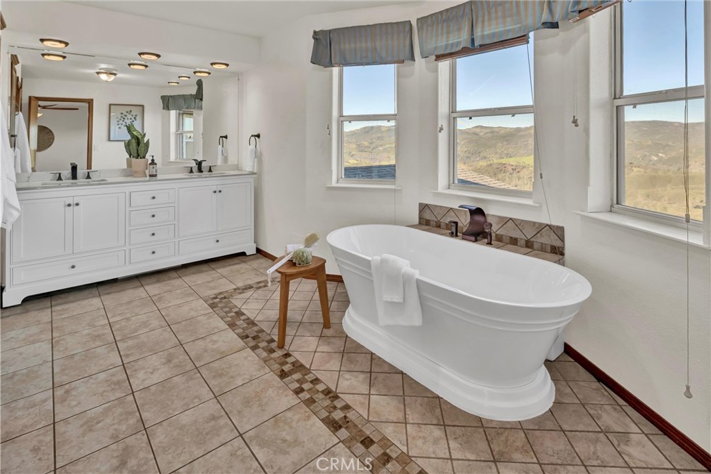20250 Black Bass Pass Road Lower Lake, CA 95457 - Photo 32 of 66 a white bath tub sitting next to a bathroom sink