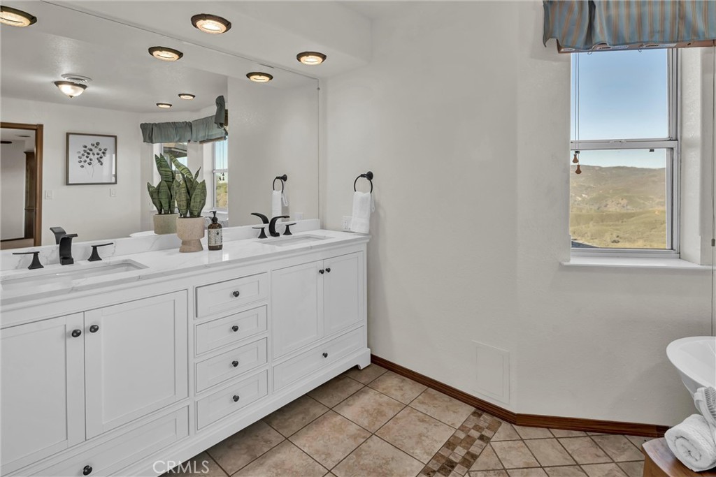 20250 Black Bass Pass Road Lower Lake, CA 95457 - Photo 34 of 66 a bathroom with a double vanity sink toilet and a mirror
