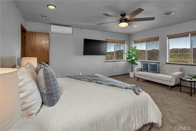 a living room with furniture a rug and a large window