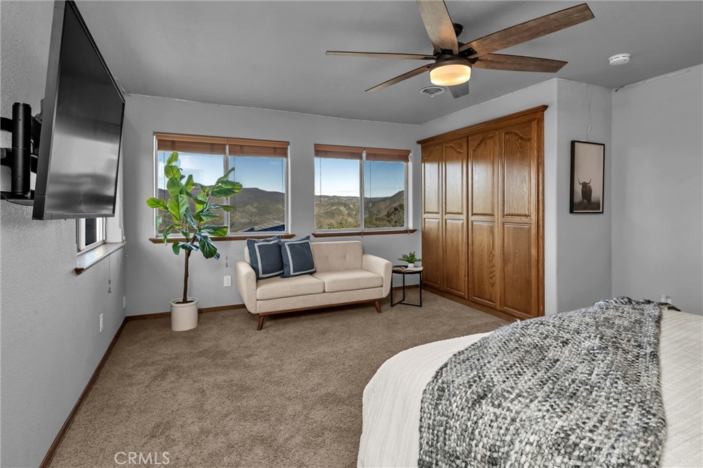 20250 Black Bass Pass Road Lower Lake, CA 95457 - Photo 38 of 66 a living room with a bed furniture and a chandelier