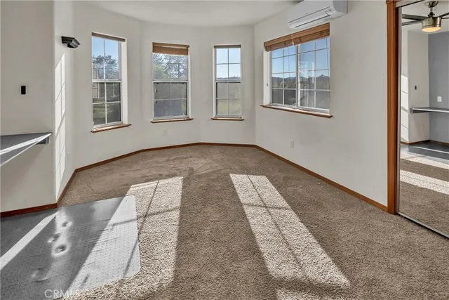 a bedroom with a bed next to a large window