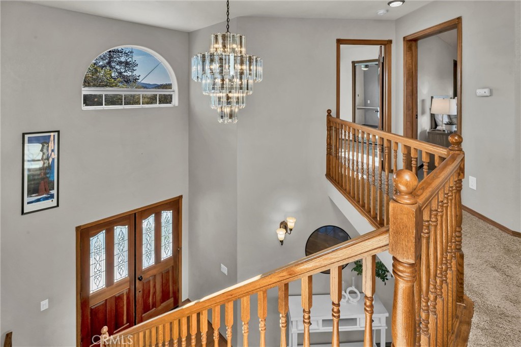 20250 Black Bass Pass Road Lower Lake, CA 95457 - Photo 42 of 66 a view of staircase with lots of frames on wall and a large window