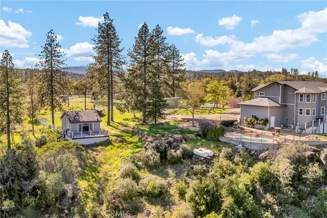 a view of a house with a yard and sitting area