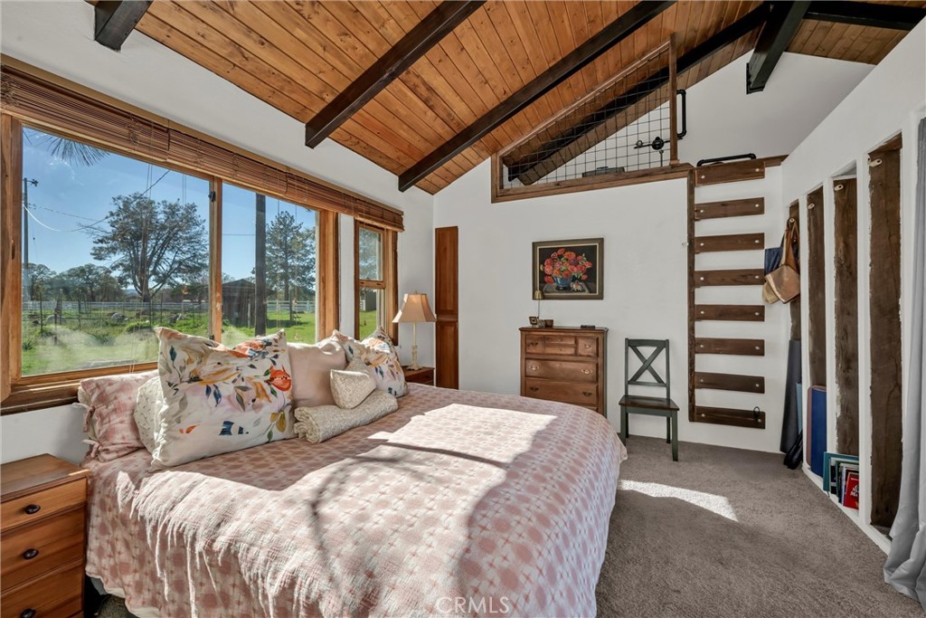 20250 Black Bass Pass Road Lower Lake, CA 95457 - Photo 54 of 66 a bedroom with a bed next to a large window