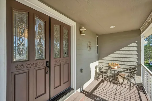 a living room with furniture a flat screen tv and floor to ceiling window