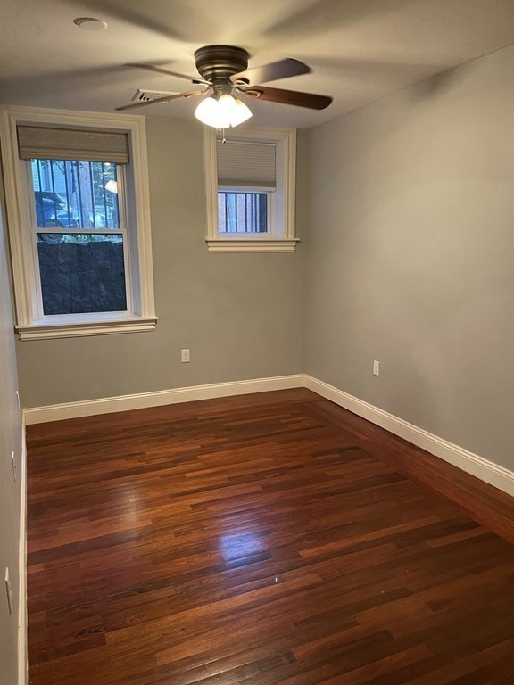 1 Wigglesworth Street, Unit 1 Boston, MA 02120 - Photo 17 of 39 a view of an empty room with wooden floor and a window