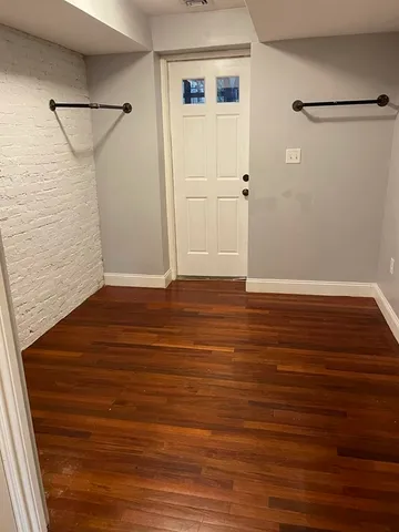 a view of a room with wooden floor