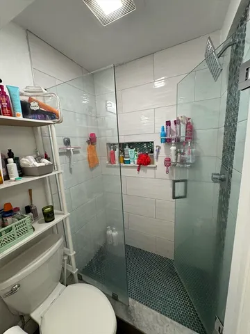 a bathroom with sink mirror and toilet