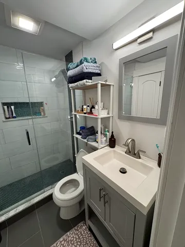 a bathroom with a sink toilet and shower