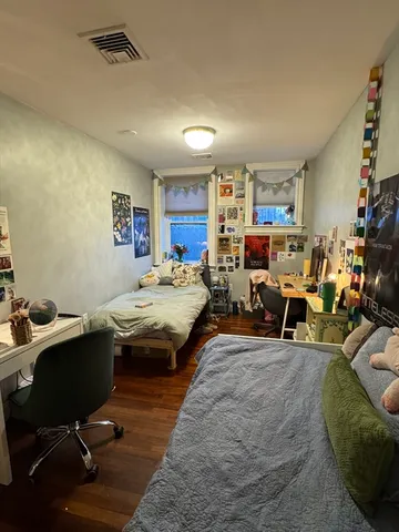 a bed room with a bed and a chair