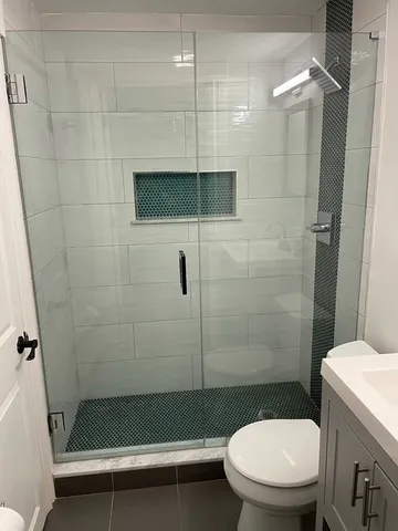 a bathroom with a toilet and a shower