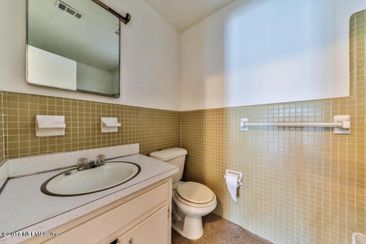 1713 El Camino Road, Unit 7 Jacksonville, FL 32216 - Photo 14 of 17 a bathroom with a sink a toilet and mirror