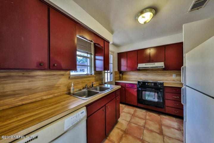 1713 El Camino Road, Unit 7 Jacksonville, FL 32216 - Photo 7 of 17 a kitchen with stainless steel appliances granite countertop wooden cabinets a stove top oven a sink and dishwasher