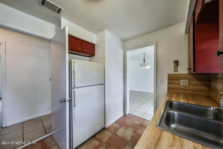 1713 El Camino Road, Unit 7 Jacksonville, FL 32216 - Photo 9 of 17 a view of a refrigerator in kitchen and an empty room