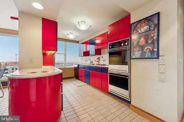 a large kitchen with stainless steel appliances granite countertop a stove a sink dishwasher and a refrigerator