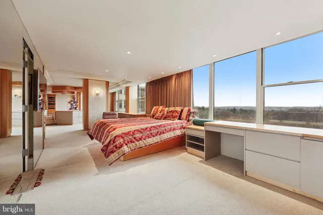 a bedroom with furniture and large window