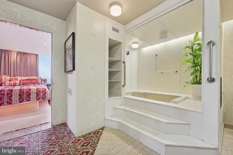 a bathroom with a bathtub and a shower