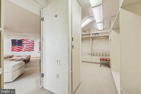 a view of walk in closet and bedroom