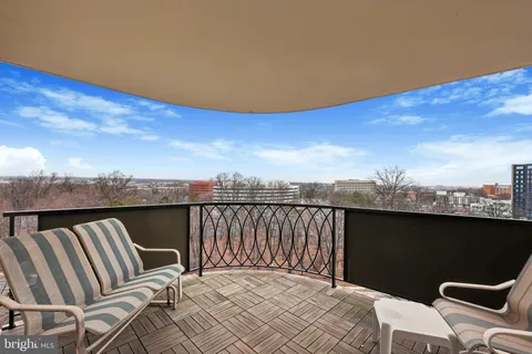 a living room with furniture cabinets and a window