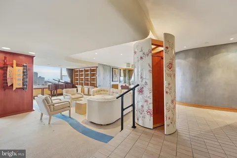 a living room with furniture a flat screen tv and a table