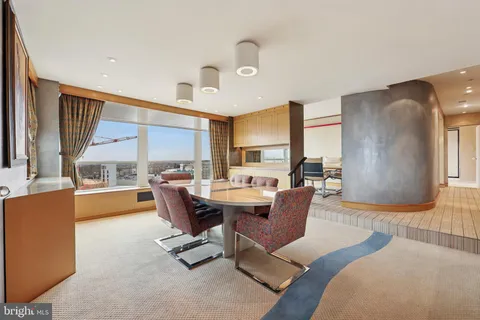 a view of a dining room with furniture and a kitchen