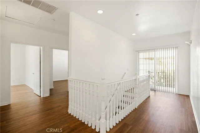 a view of a hallway with wooden floor and entryway