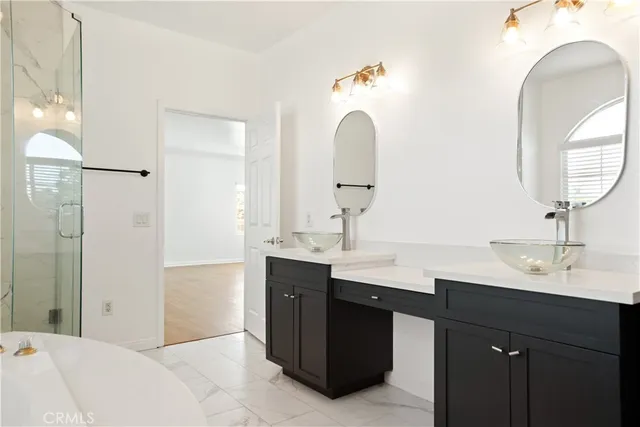 a en suite bathroom with a double vanity sink and a mirror