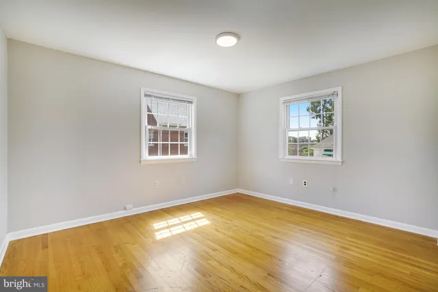 a view of a room with wooden floor and window