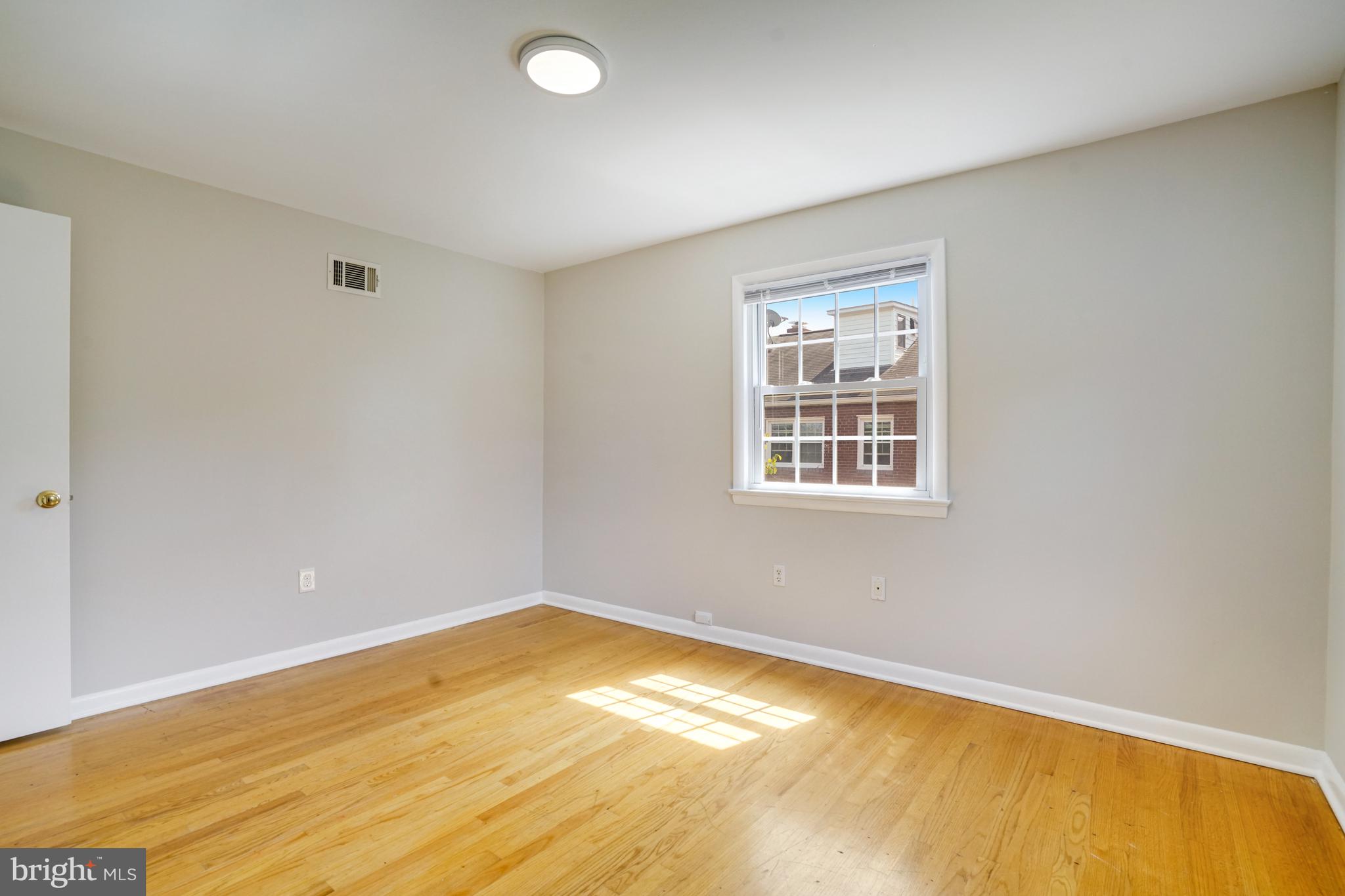 706 North Cleveland Street Arlington, VA 22201 - Photo 18 of 59 a view of a room with wooden floor and window