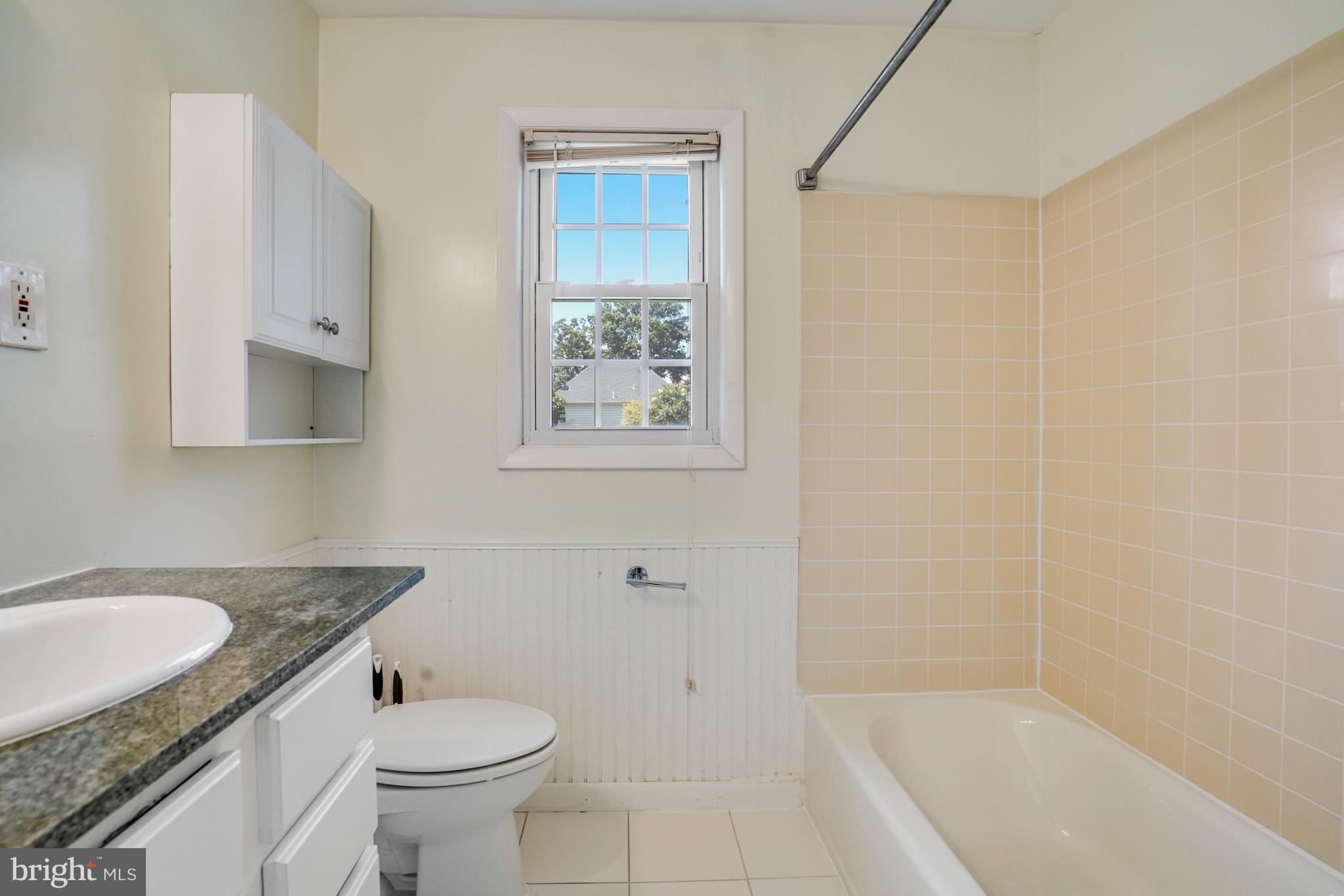 706 North Cleveland Street Arlington, VA 22201 - Photo 20 of 59 a bathroom with a granite countertop sink toilet and shower
