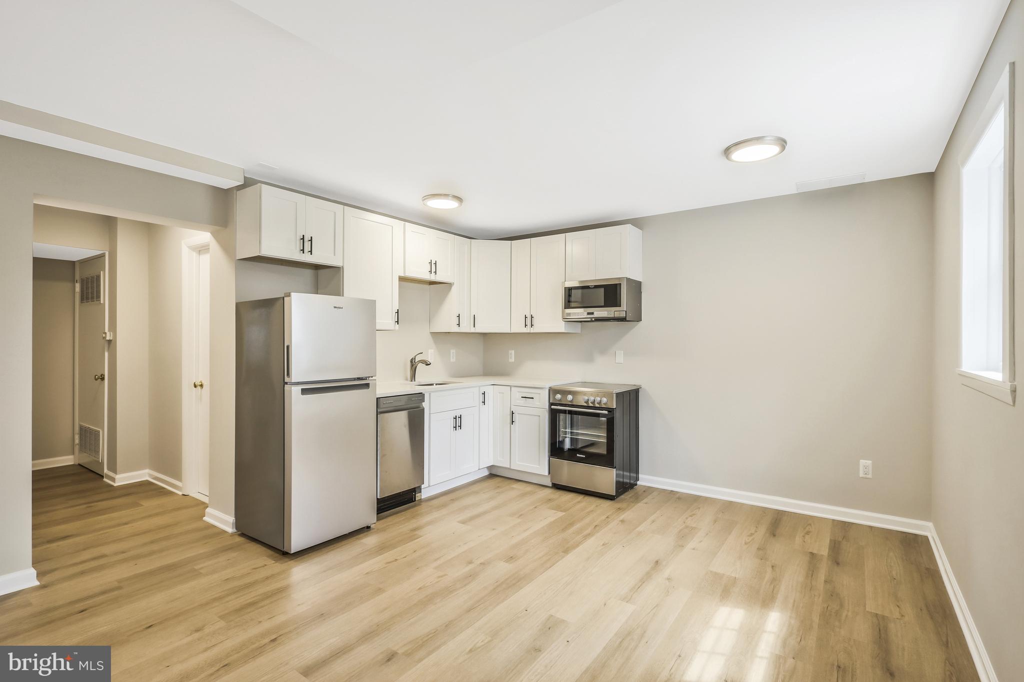 706 North Cleveland Street Arlington, VA 22201 - Photo 31 of 59 a kitchen with stainless steel appliances a refrigerator and a stove top oven