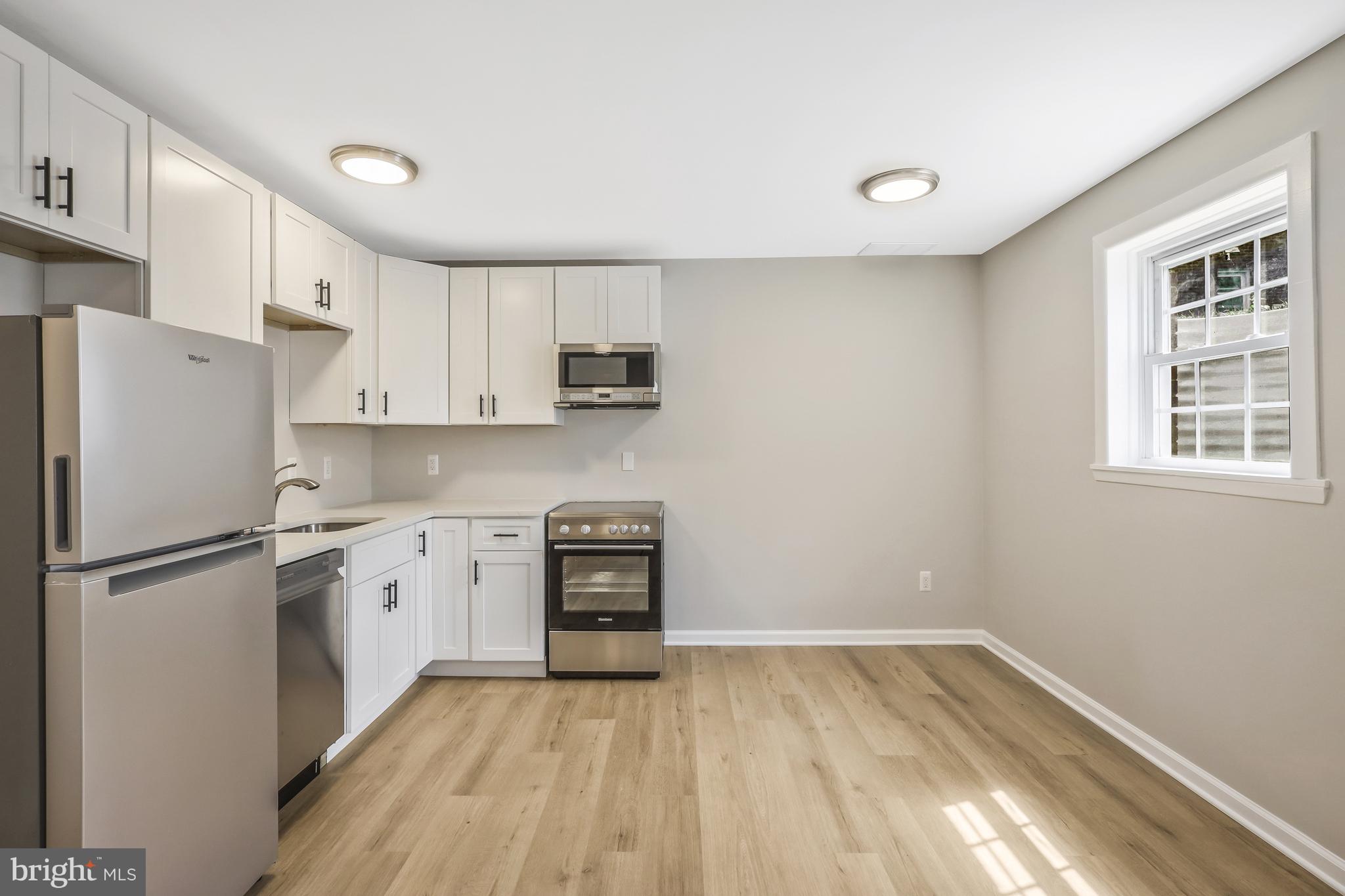 706 North Cleveland Street Arlington, VA 22201 - Photo 32 of 59 a kitchen with stainless steel appliances a refrigerator sink and microwave