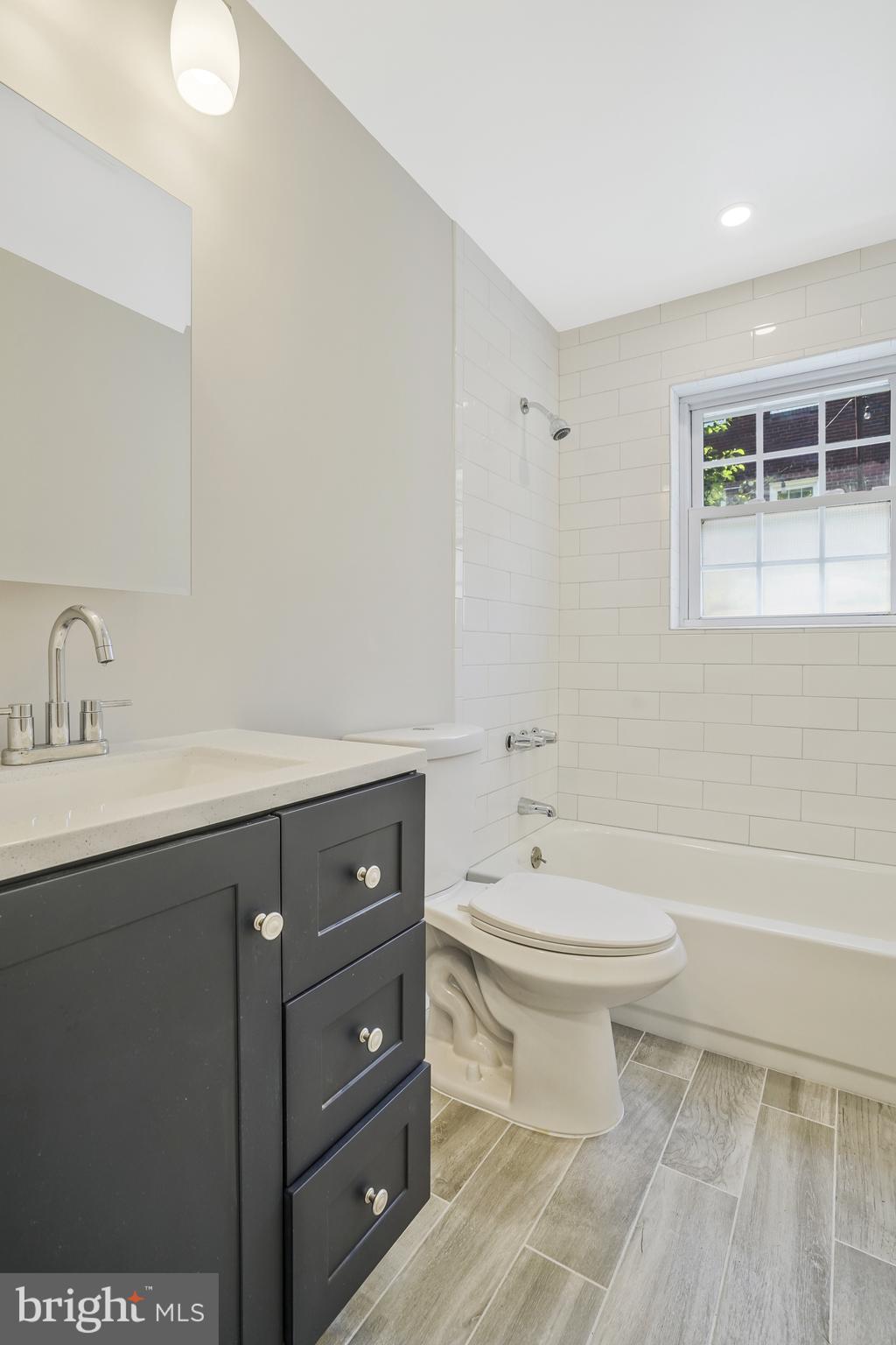 706 North Cleveland Street Arlington, VA 22201 - Photo 38 of 59 a bathroom with a sink a toilet and shower