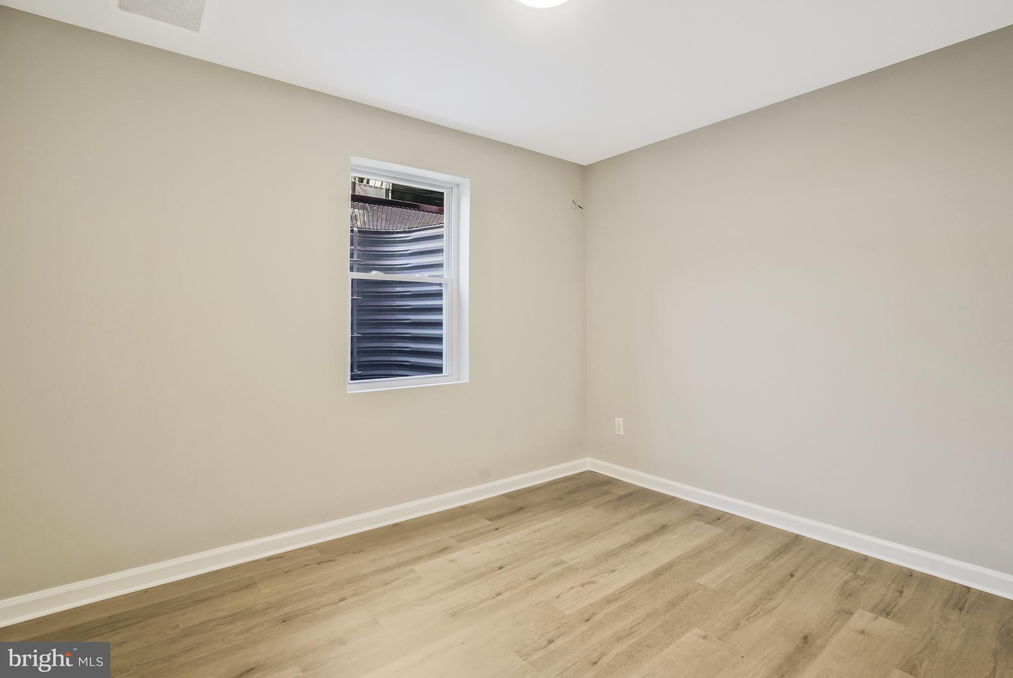 706 North Cleveland Street Arlington, VA 22201 - Photo 39 of 59 a view of an empty room with wooden floor and a window