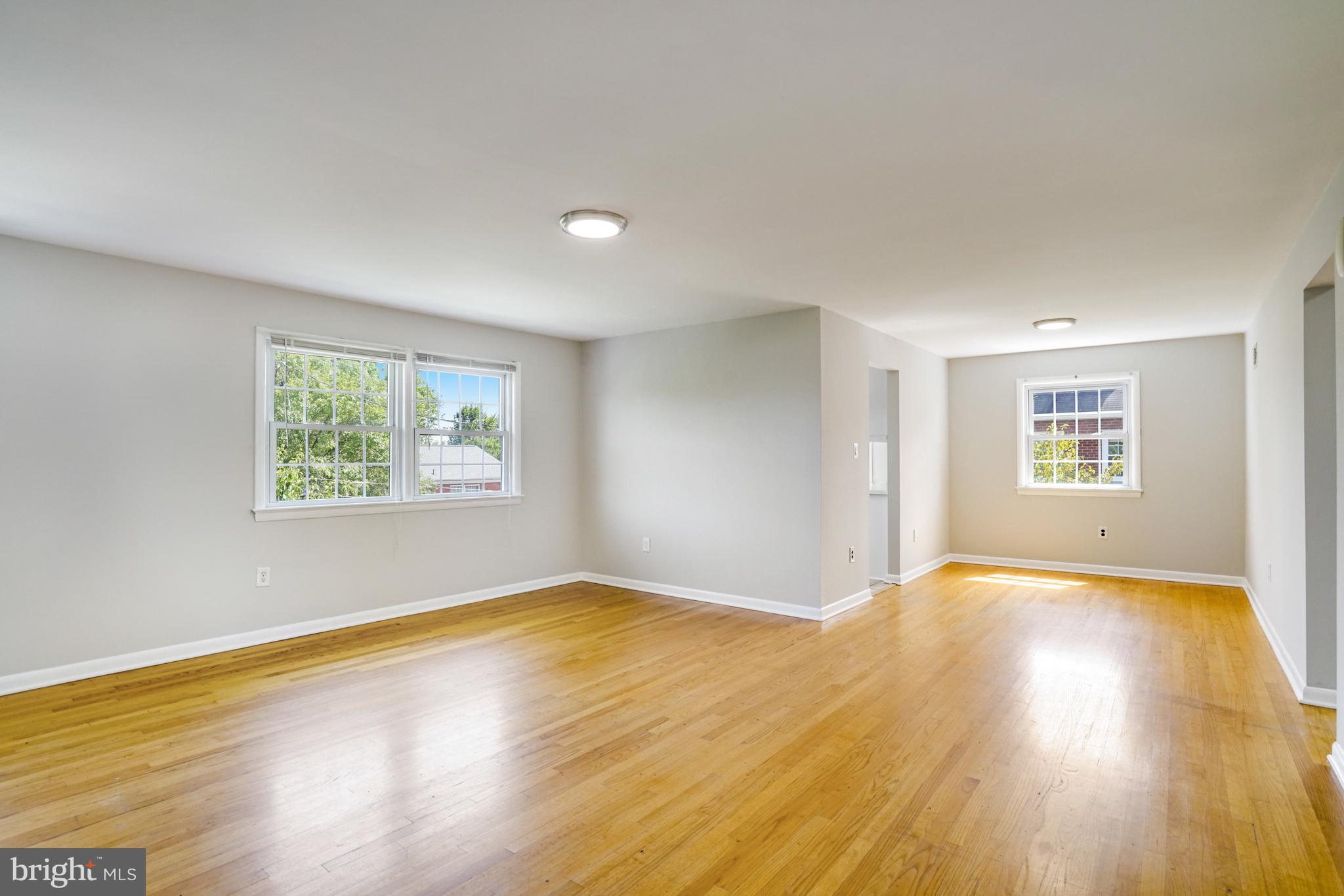 706 North Cleveland Street Arlington, VA 22201 - Photo 4 of 59 a view of an empty room with wooden floor and a window