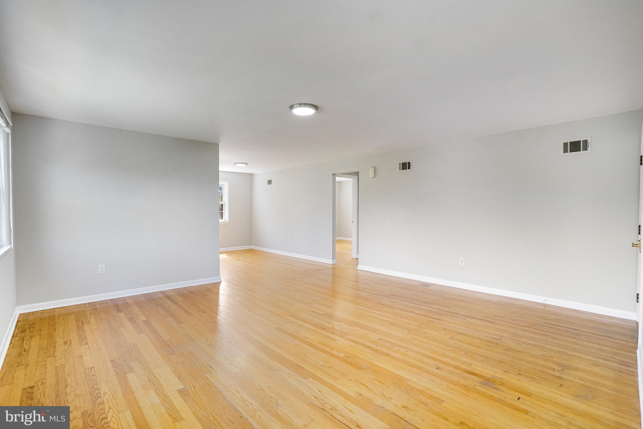 706 North Cleveland Street Arlington, VA 22201 - Photo 7 of 59 a view of an empty room with wooden floor