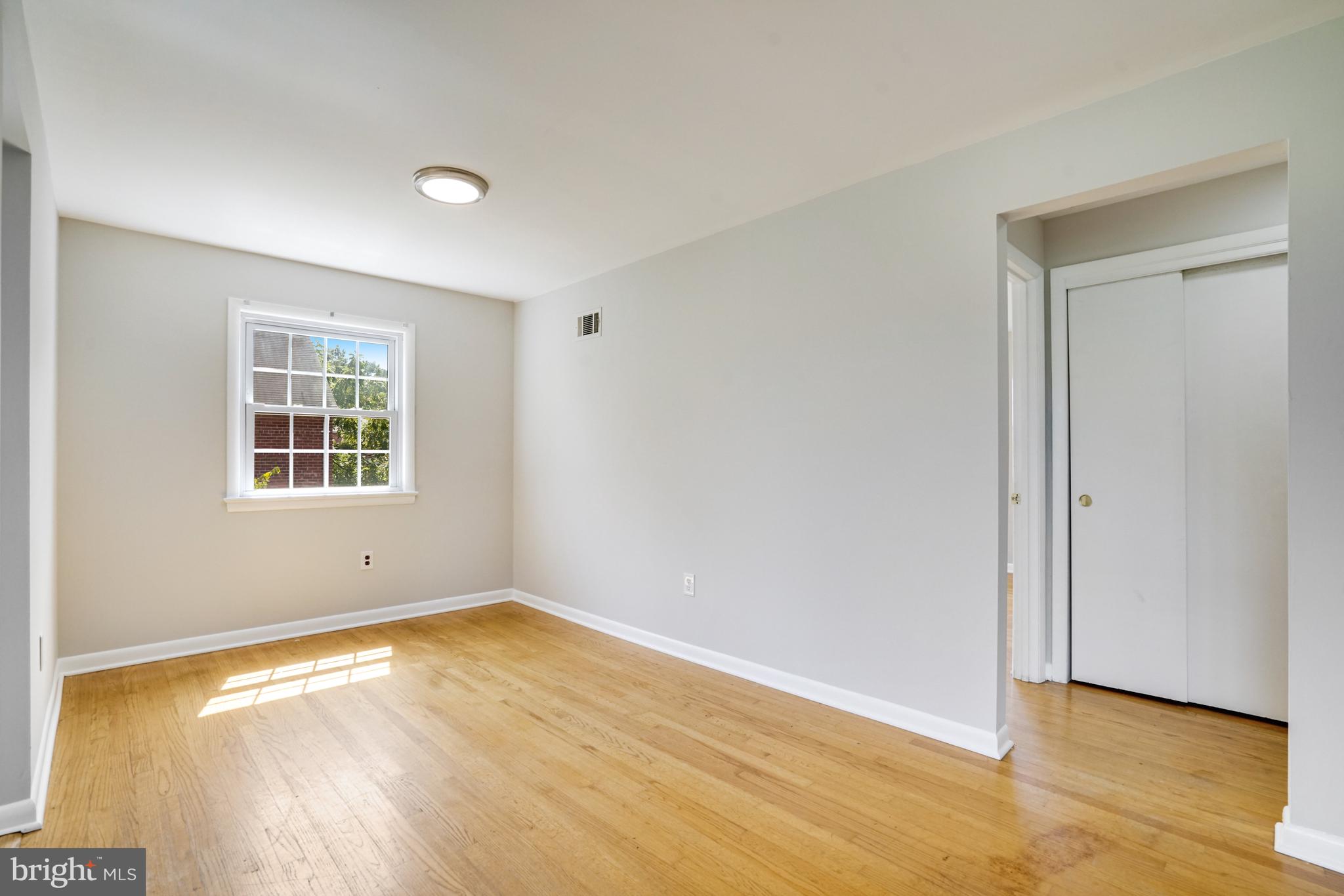 706 North Cleveland Street Arlington, VA 22201 - Photo 9 of 59 an empty room with wooden floor and windows
