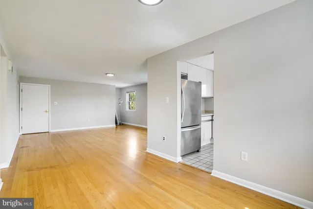 a view of a kitchen with a sink and a refrigerator
