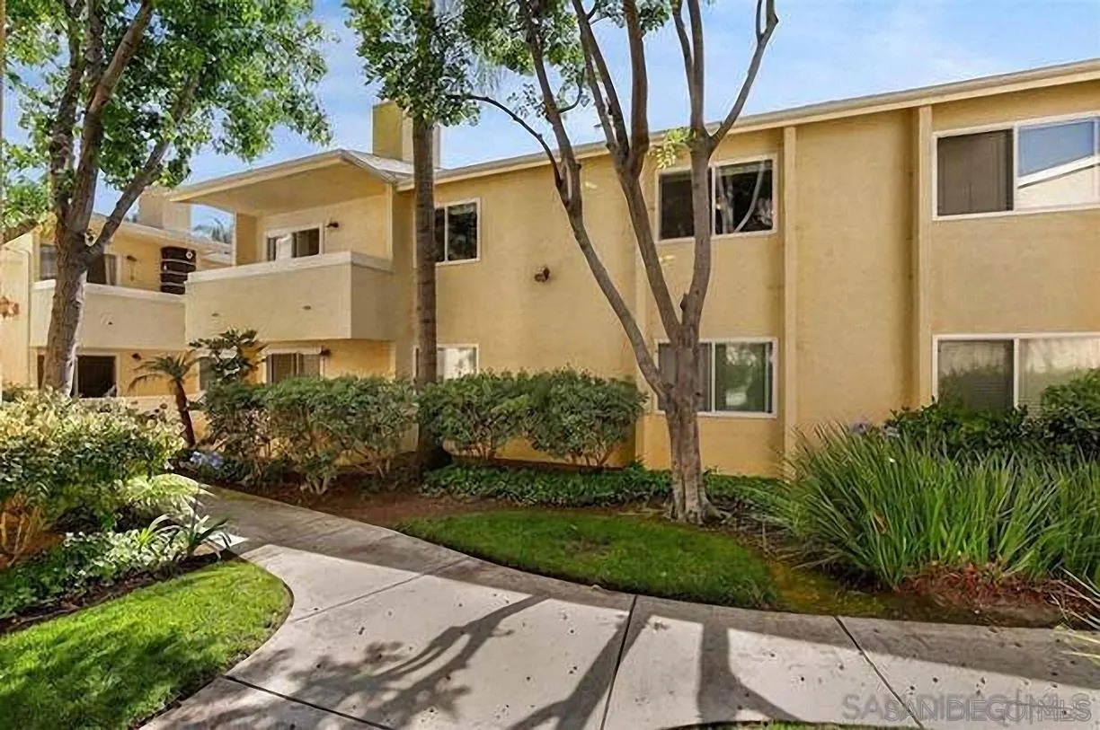 9929 Erma Road, Unit 102 San Diego, CA 92131 - Photo 1 of 14 a front view of a house with a yard and potted plants
