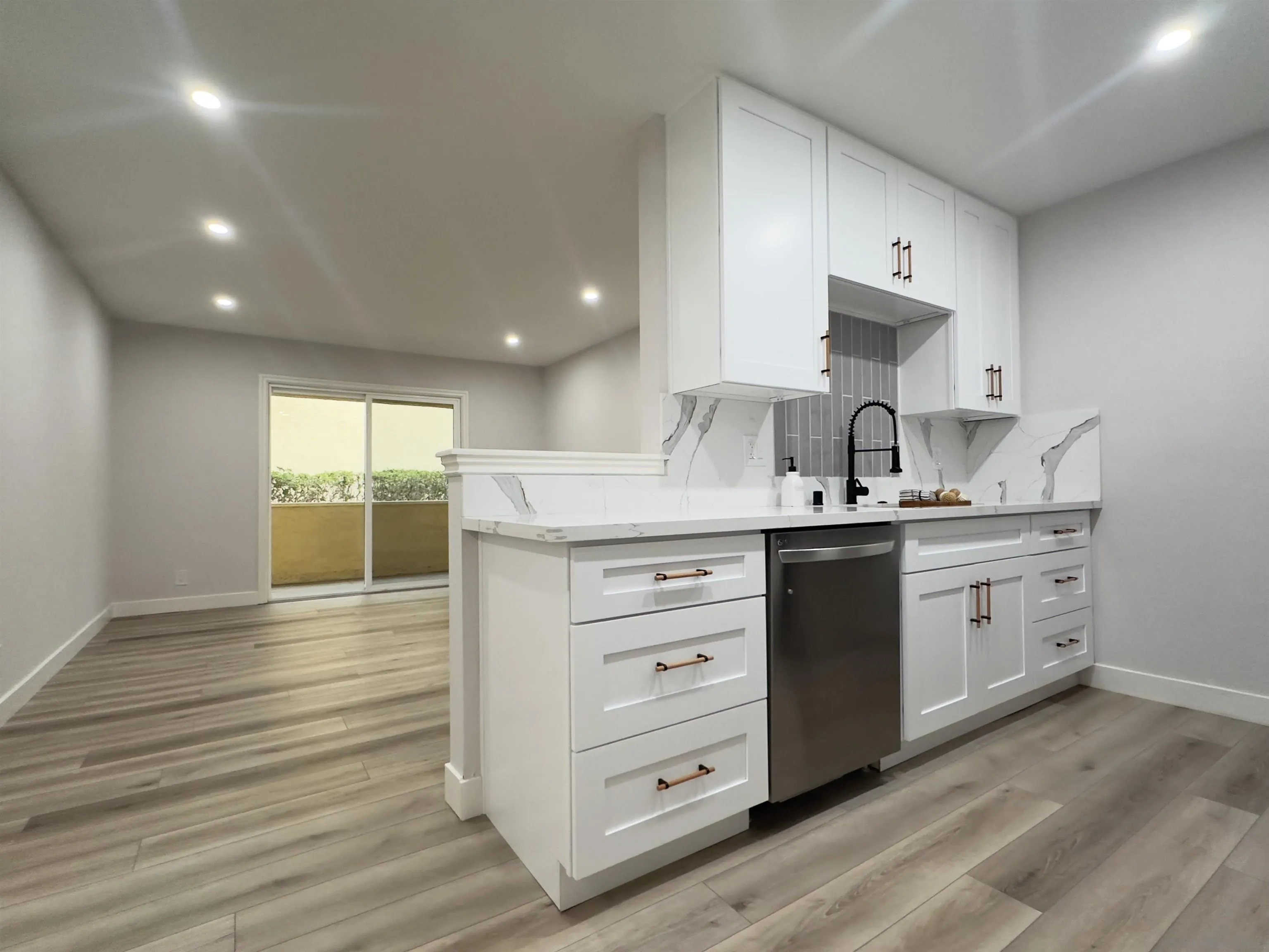 9929 Erma Road, Unit 102 San Diego, CA 92131 - Photo 2 of 14 a kitchen with a sink cabinets and wooden floor