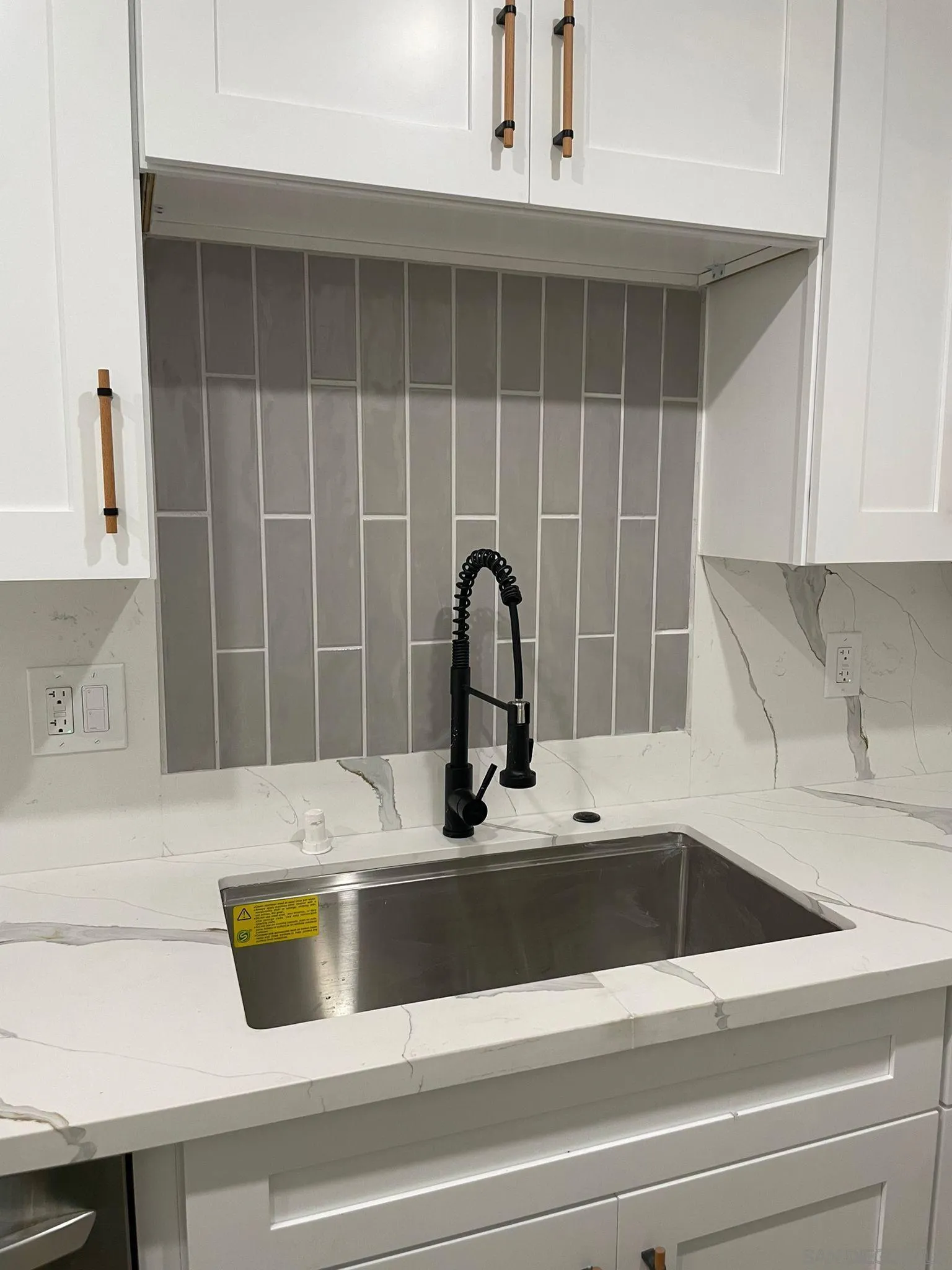 9929 Erma Road, Unit 102 San Diego, CA 92131 - Photo 8 of 14 a close view of a sink and dishwasher with kitchen island