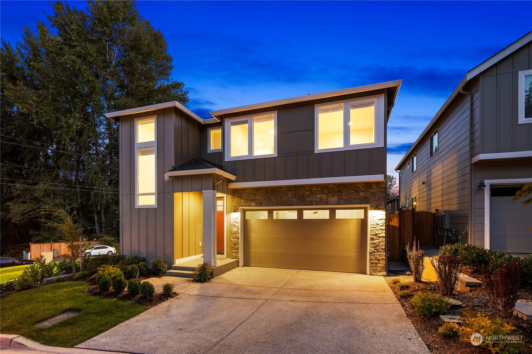 1302 197th Place Southeast Bothell, WA 98012 - Photo 1 of 35 a front view of a house with a yard