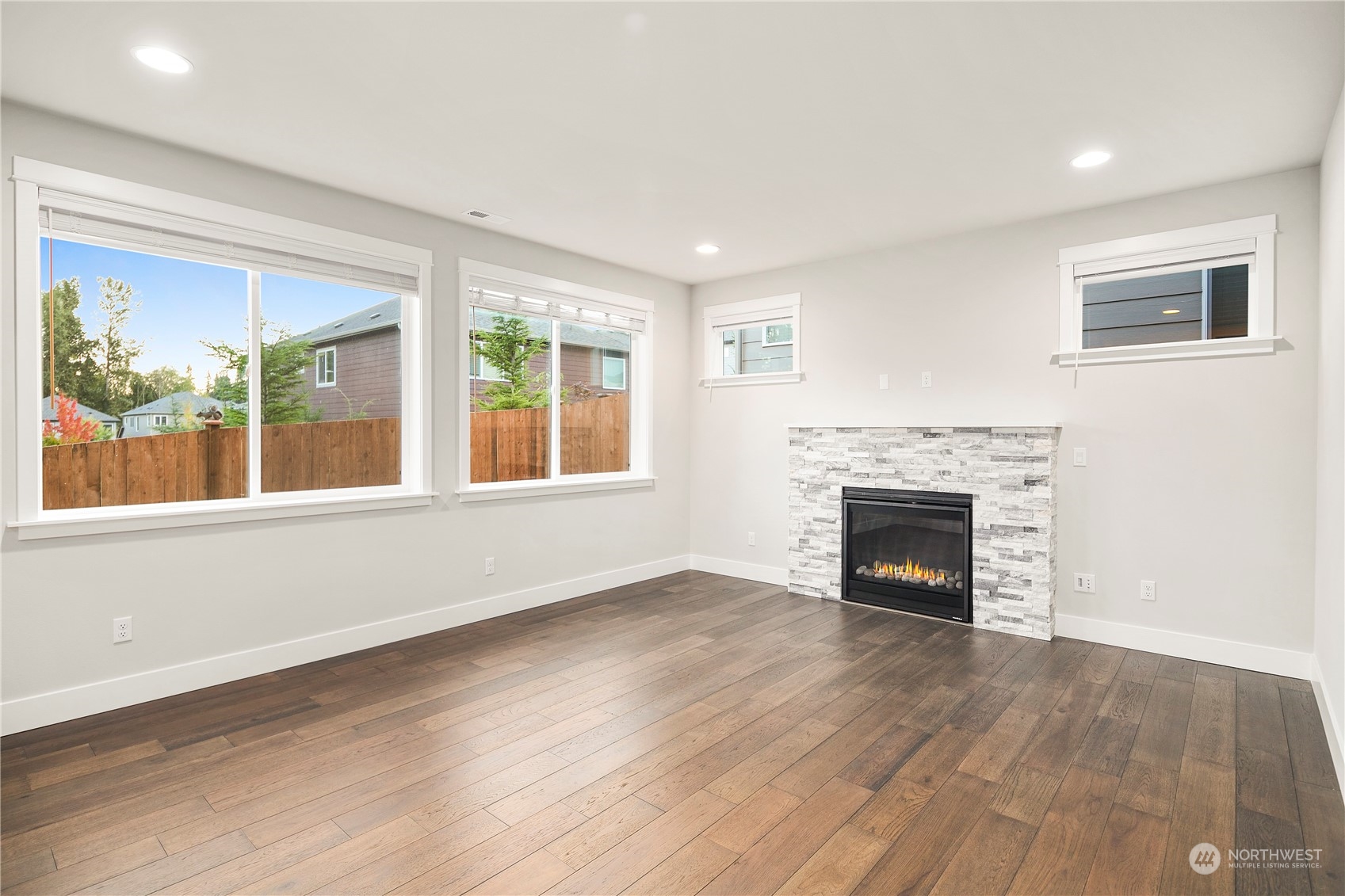 1302 197th Place Southeast Bothell, WA 98012 - Photo 12 of 35 a view of empty room with wooden floor and fireplace