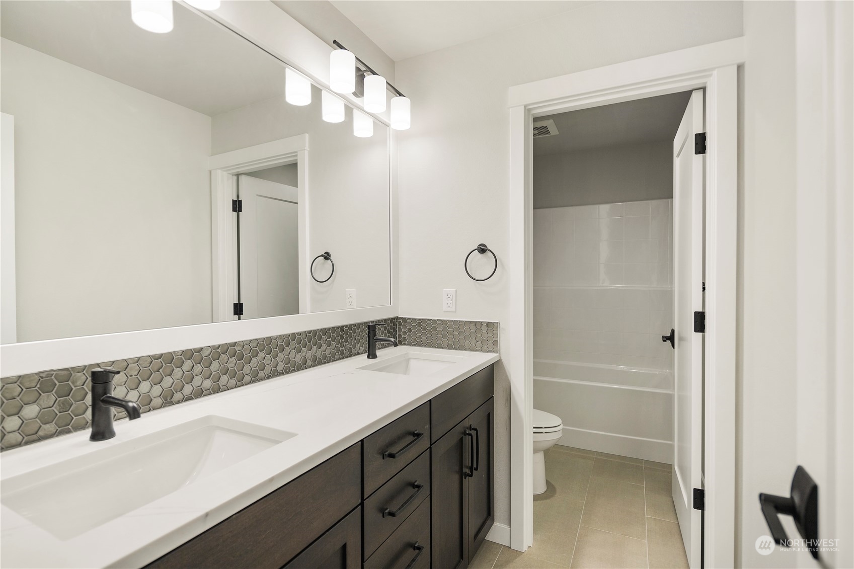 1302 197th Place Southeast Bothell, WA 98012 - Photo 32 of 35 a bathroom with a sink and a mirror