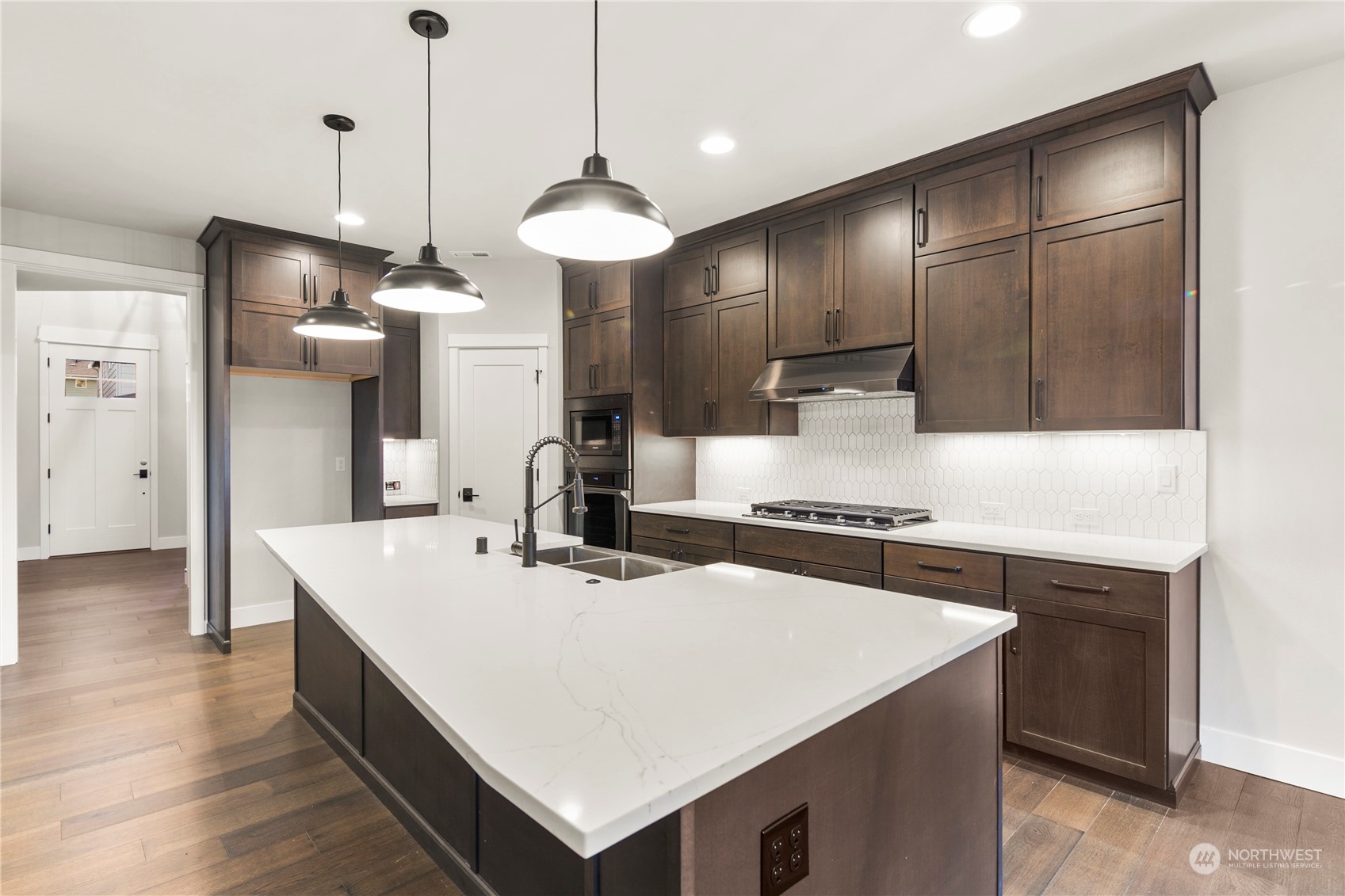 1302 197th Place Southeast Bothell, WA 98012 - Photo 9 of 35 a kitchen with stainless steel appliances a sink a stove a refrigerator and island
